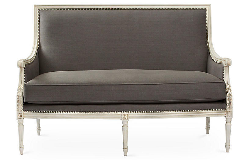 Gray upholstered French settee with white wood and nailhead trim from One Kings Lane