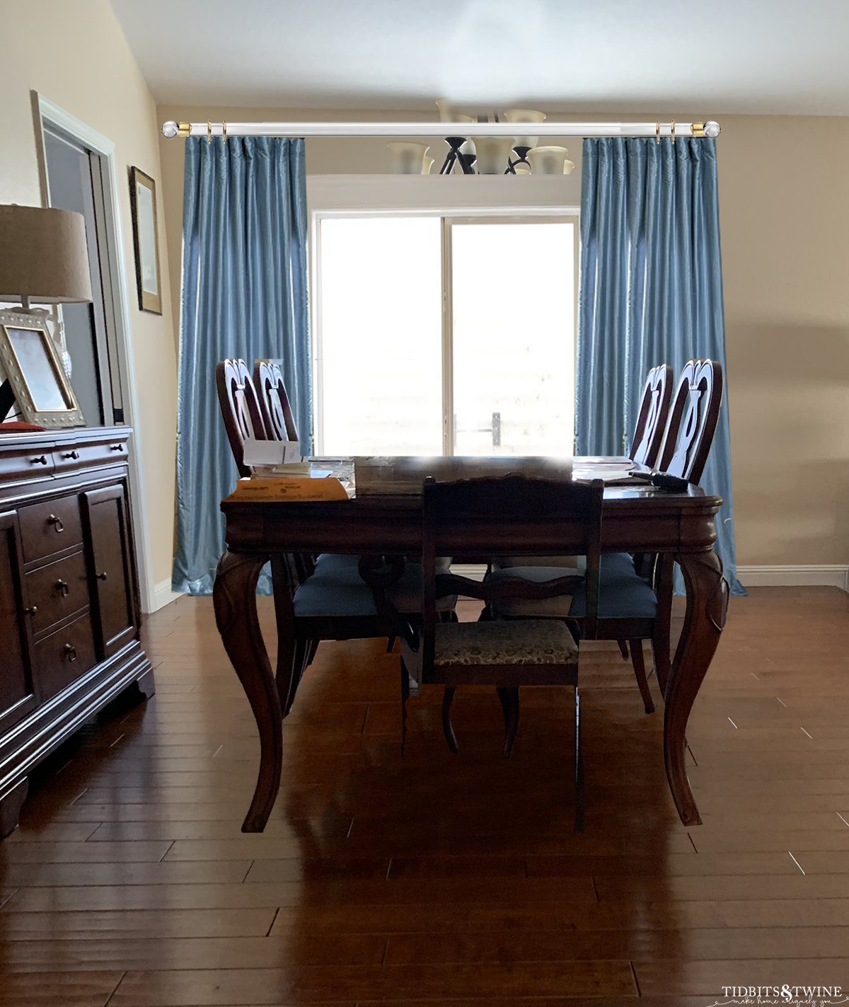 Traditional dining room dark queen anne dining table with blue silk curtains and beige walls