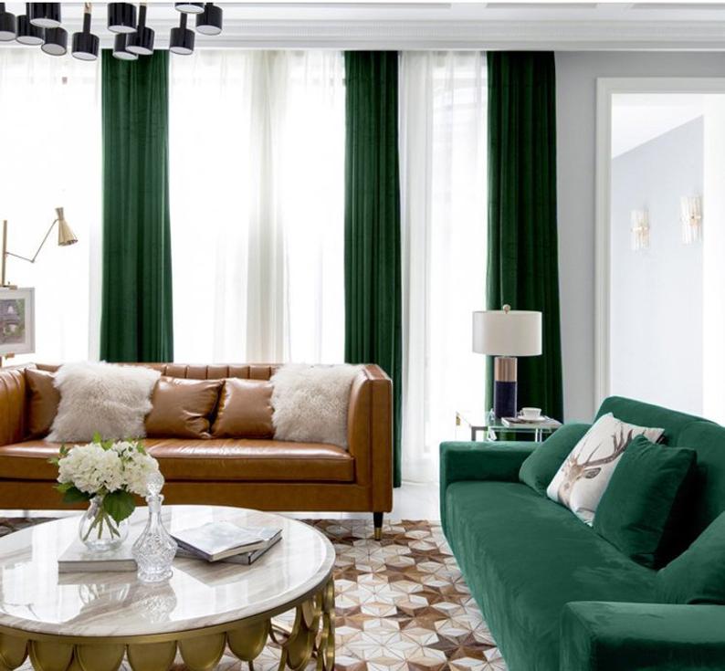 contemporary living room with green velvet curtains and sofa and geometric rug