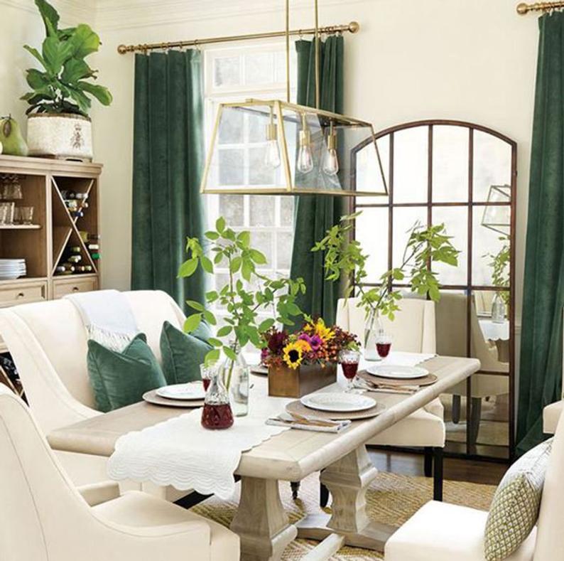 trestle dining table with white bench seat and green velvet accents