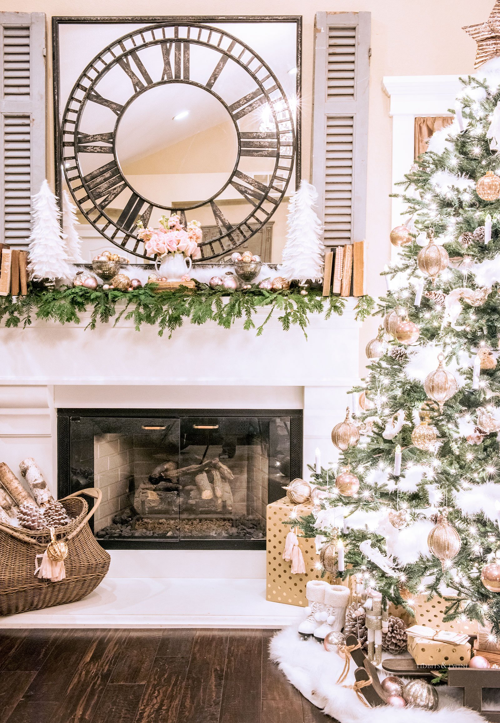 Bedroom mantel decorated for Christmas in pink gold and white with a Christmas tree nearby