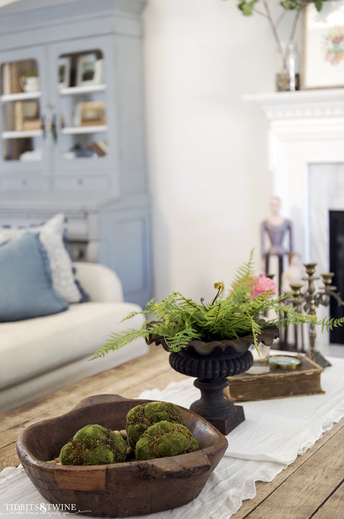 Industrial coffee table with iron urn and fern in a french living room