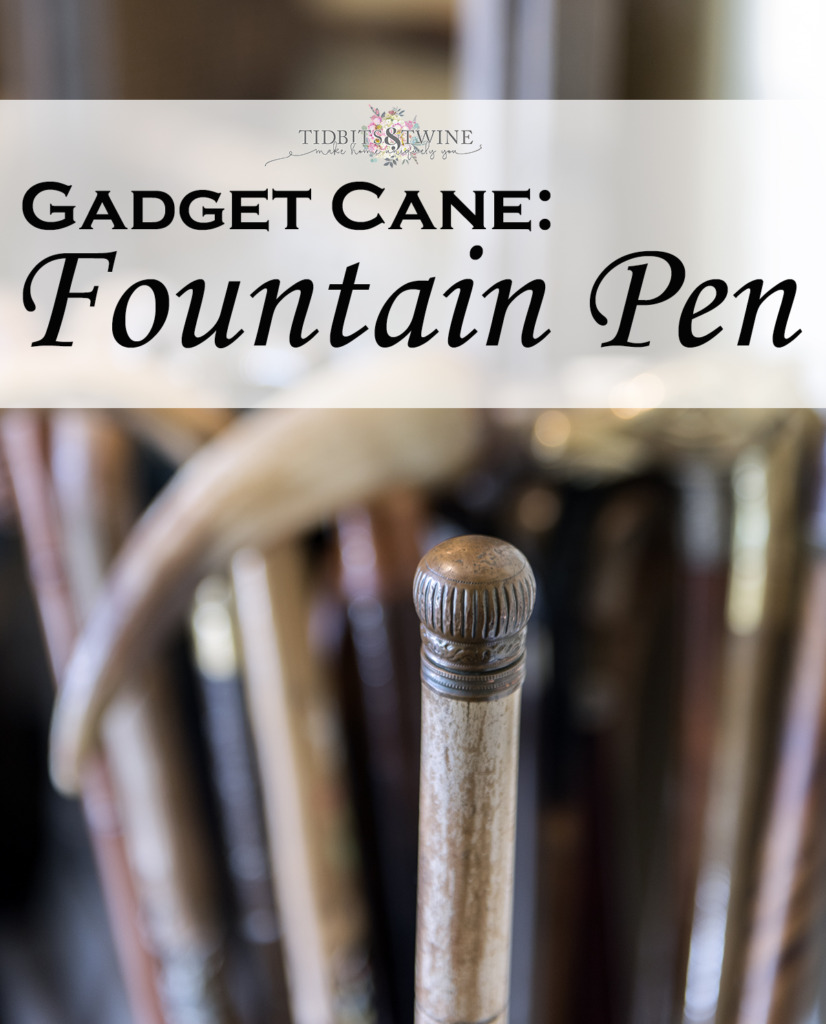 closeup of antique gadget cane with round metal top that is a fountain pen