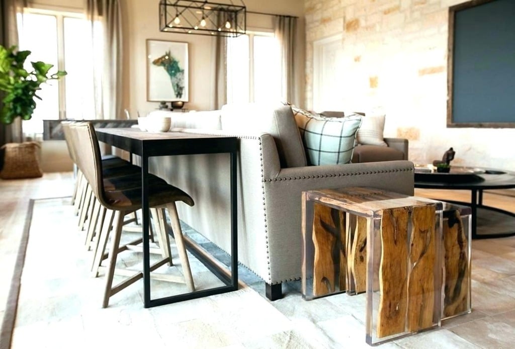 narrow dining bar table behind a sofa in an industrial living room