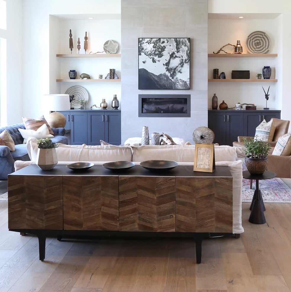 contemporary living room with buffet behind sofa and built in shelving next to fireplace