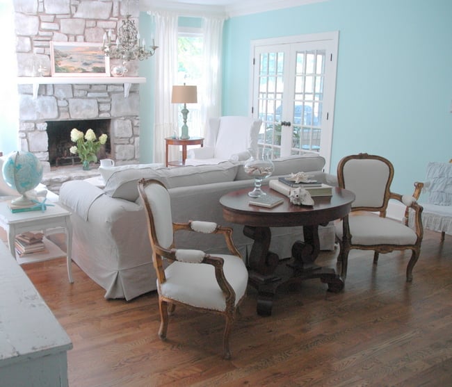 small french table and chairs behind the sofa in a living room