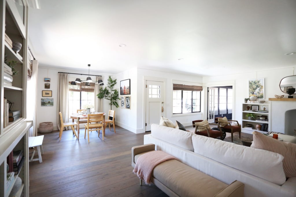 open floorplan with upholstered bench behind sofa