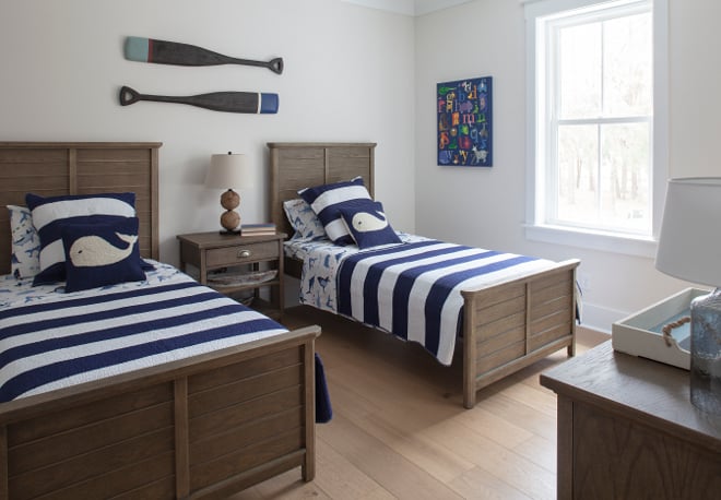 Bedroom painted with heron plume with twin wooden beds and blue stripped bedding for a neautical theme