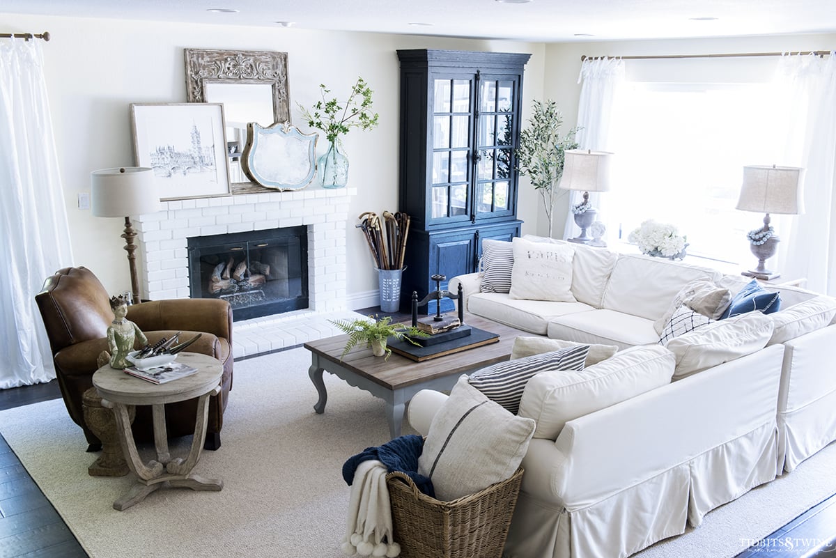 large family room seating area on custom rug with slipcovered sectional and leather reclining chair