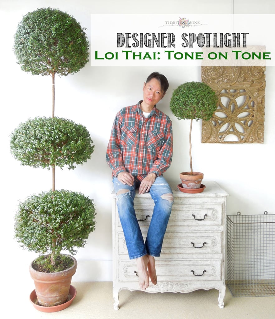 designer loi thai sitting on white chest next to myrtle topiaries in terracotta pots white walls