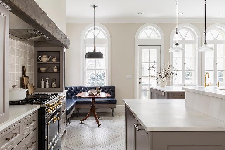 traditional kitchen painted winds breath with gray cabinets and black stove with beam over chimney and herringbone wood floors