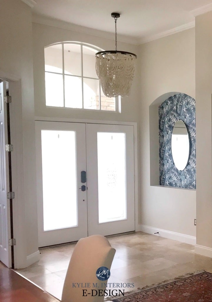 entryway painted with neutral ground double glass front doors with white surround and tile floor with beaded chandelier above