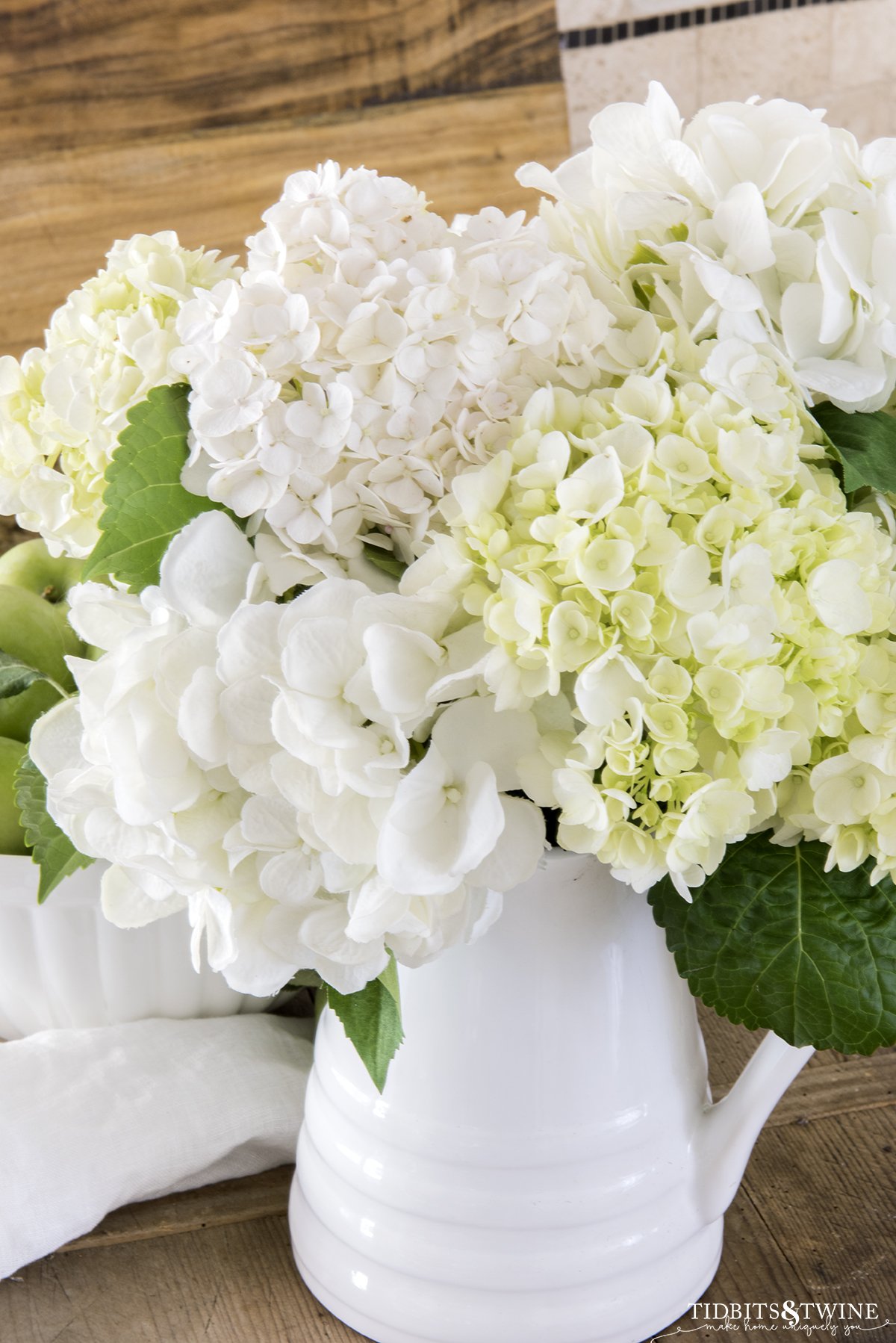 Closeup of white hydrangeas in a white pitcher