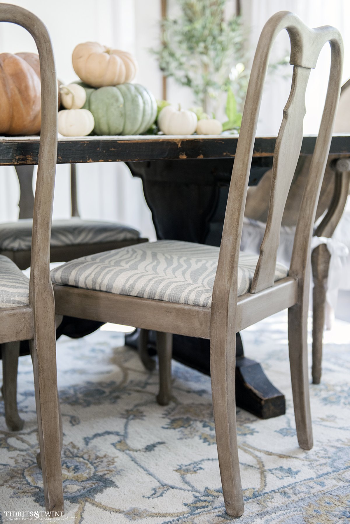 refinished gustavian dining chair with faux wood finish and modern zebra print on chair seat in french dining room