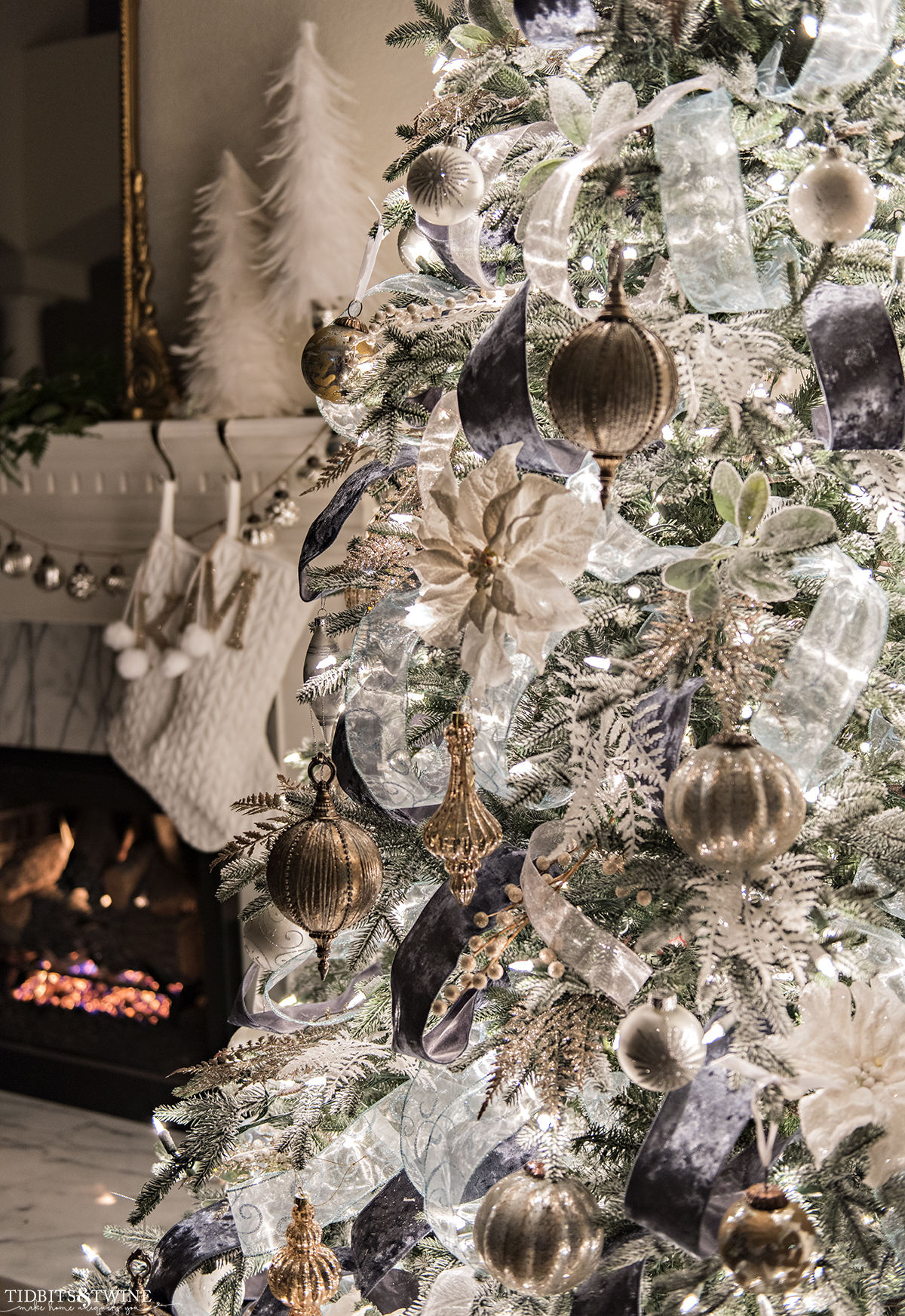 closeup of french Christmas tree at night with fireplace in background
