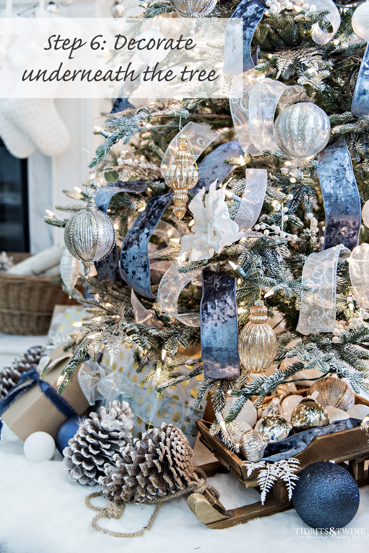 blue and white french christmas tree with fireplace mantel in background with white stockings and white feather trees