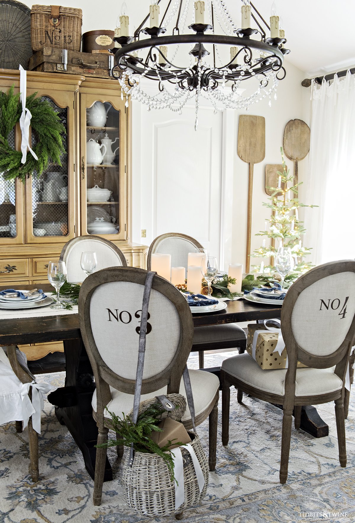 french christmas dining room with round numbered chairs and small christmas tree in corner