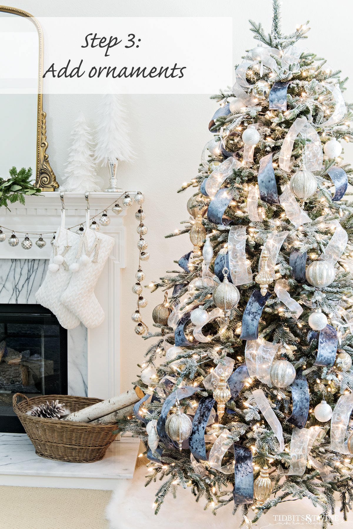 blue and white french christmas tree with fireplace mantel in background and presents and ornaments around base