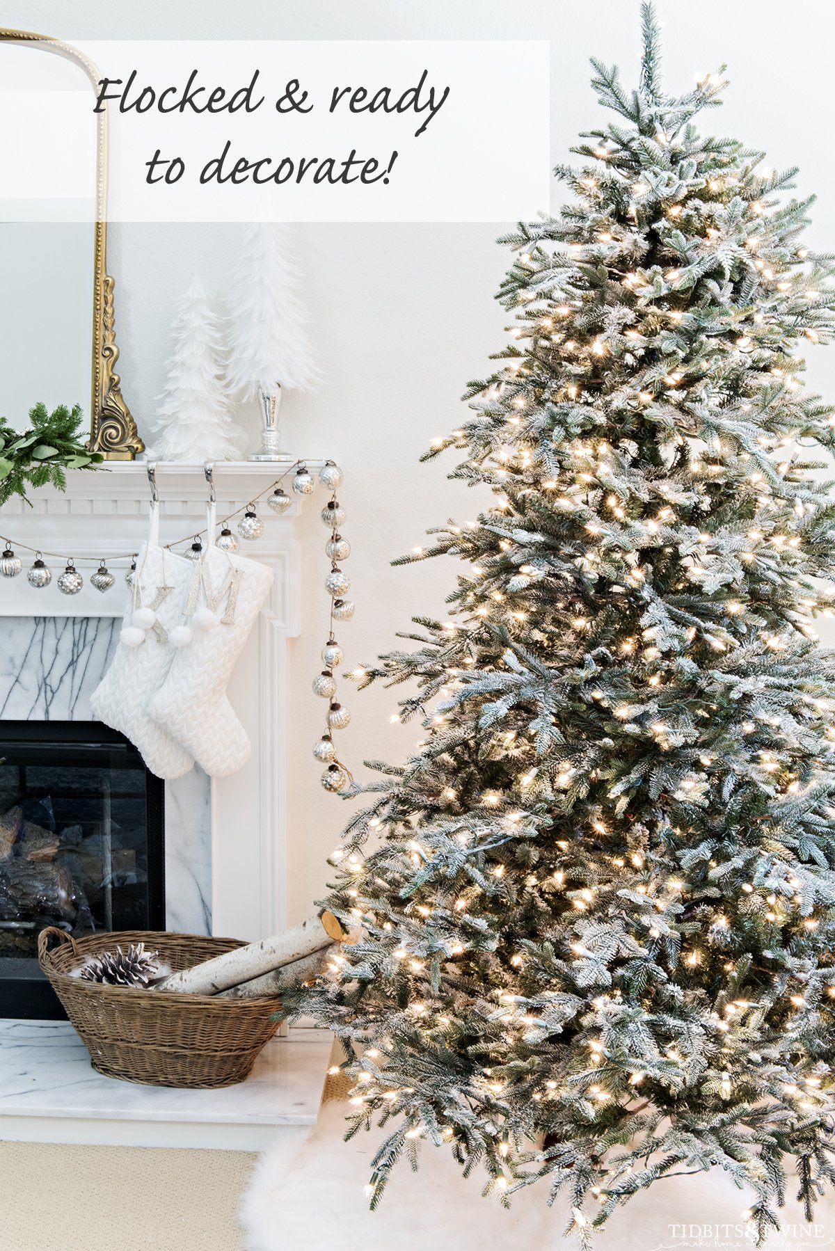 lightly flocked christmas tree ready to decorate next to fireplace in living room