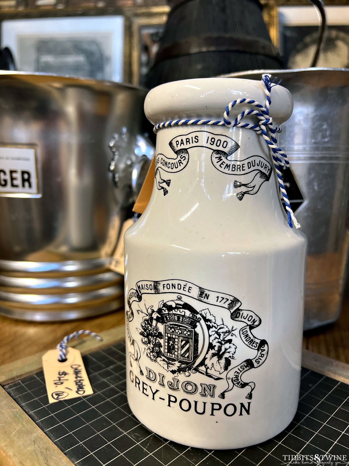 closeup of white grey poupon jar with black writing