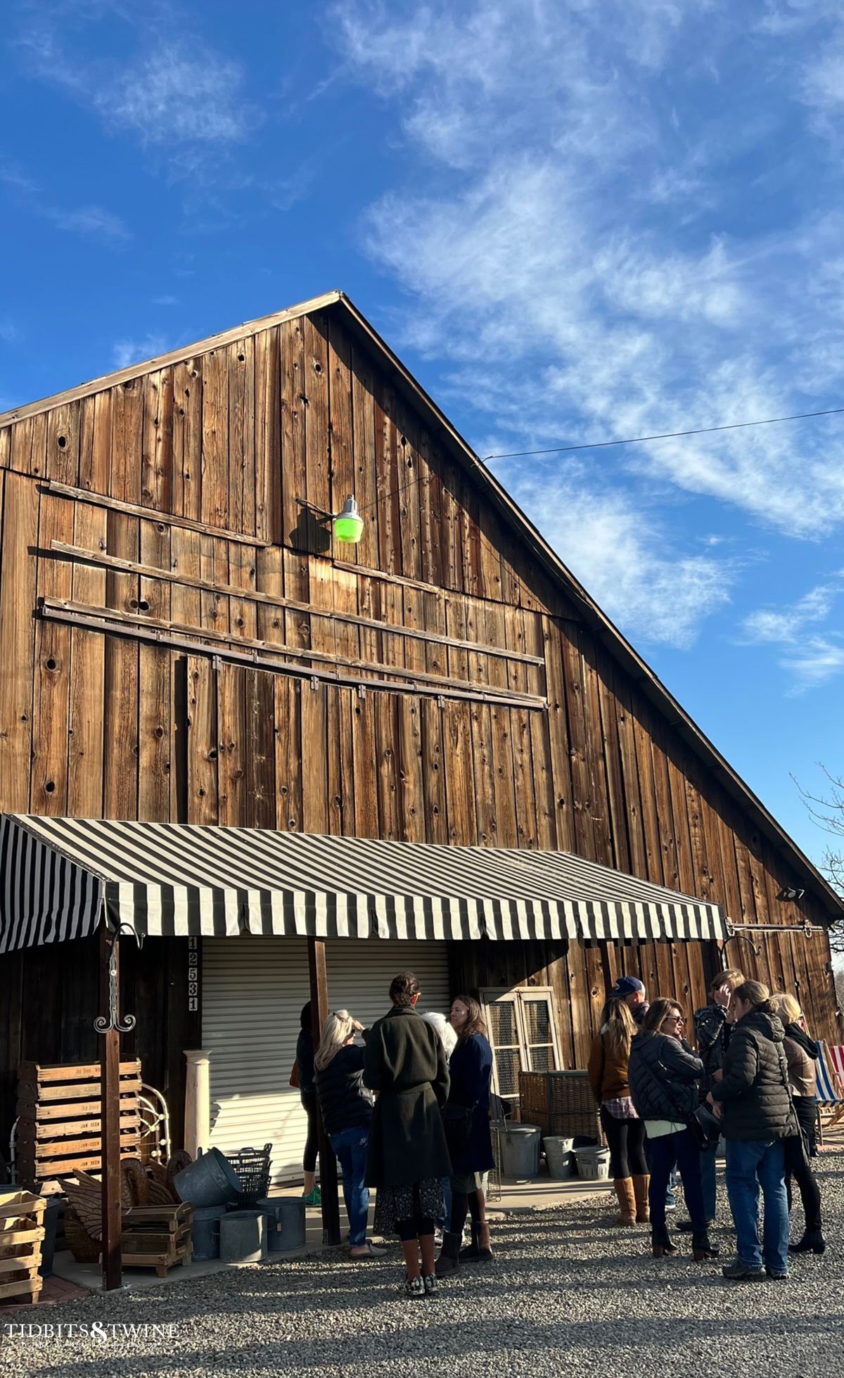 old wooden barn with black and white awning for a european container sale