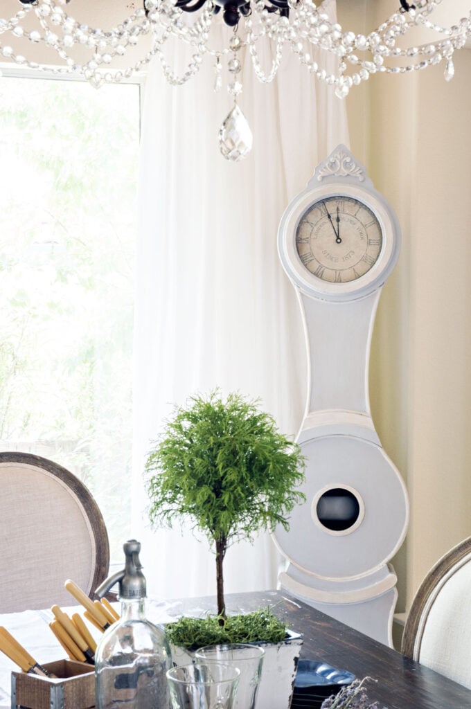 gustavian style room with blue mora clock and light blue walls with hardwood floors