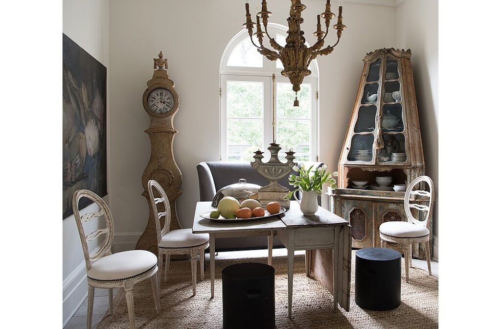 tara shaw's breakfast room with gustavian furniture and mora clock in corner