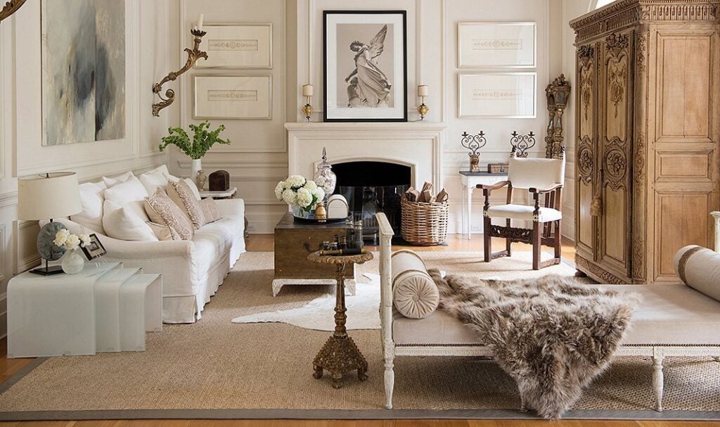 european style living room with white paneled walls and french settee and french armoire