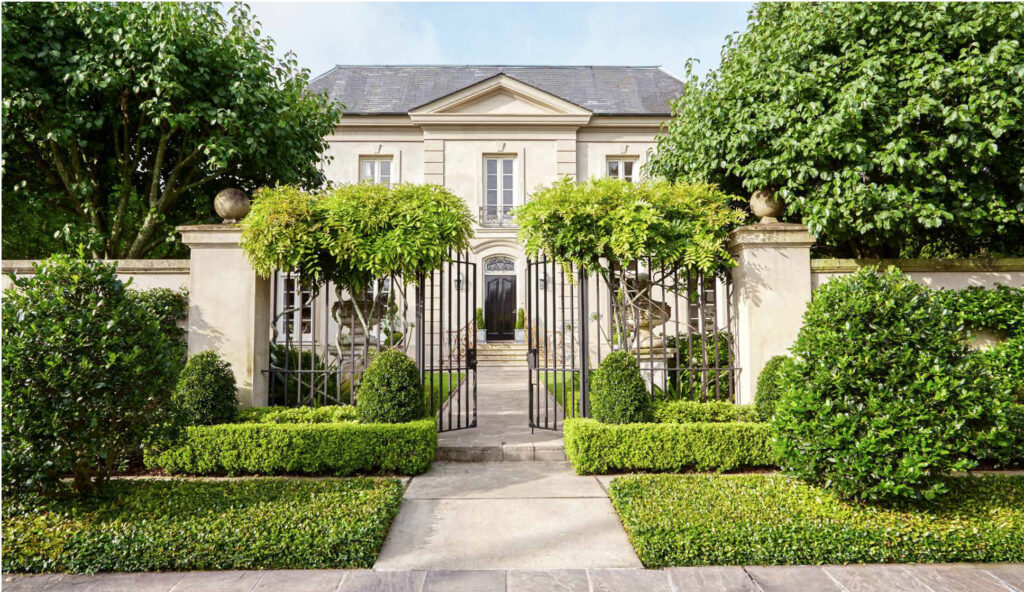 tara shaw's french style home with beige stucco and wisteria vines