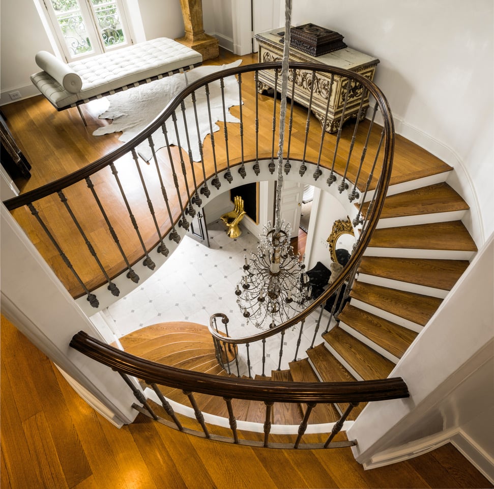 top down view of curved stairway with wood treads and white risers
