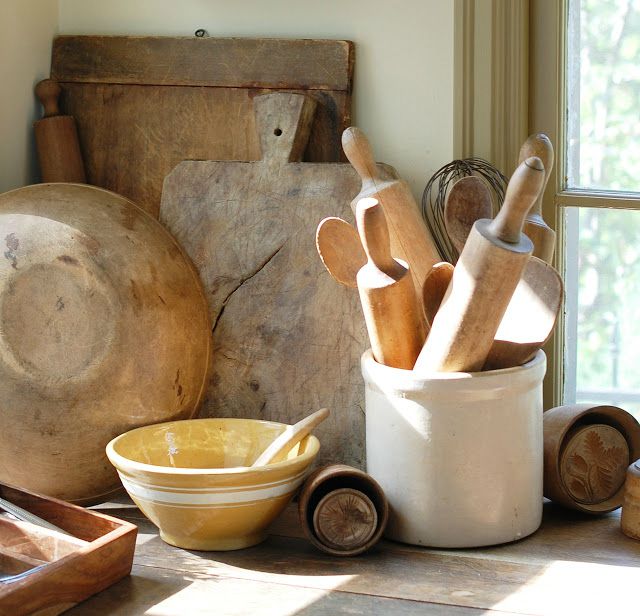 vignette of antique bread boards and crock with rolling pins