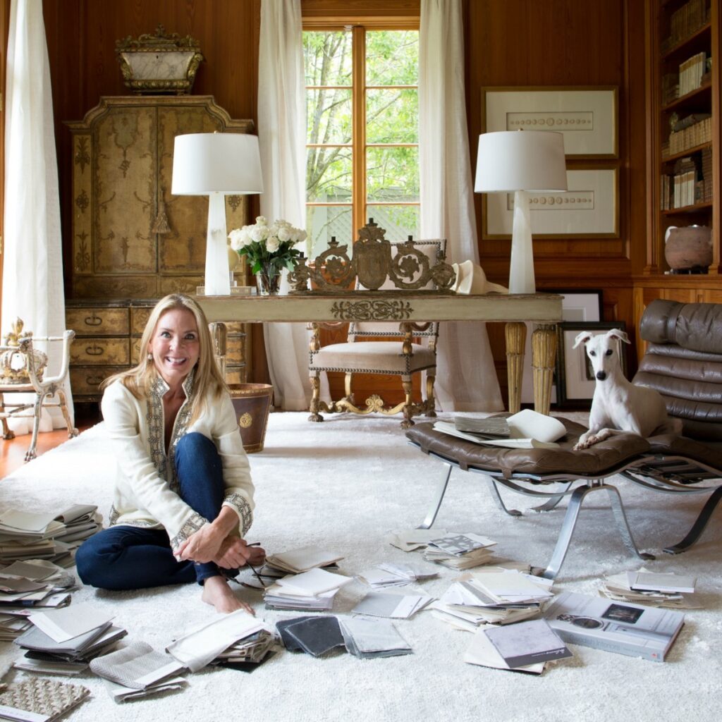 european inspired home library with leather chair and designer tara shaw sitting on floor