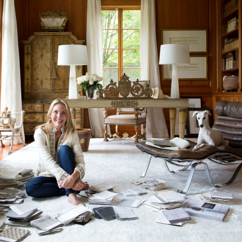 european inspired home library with leather chair and designer tara shaw sitting on floor