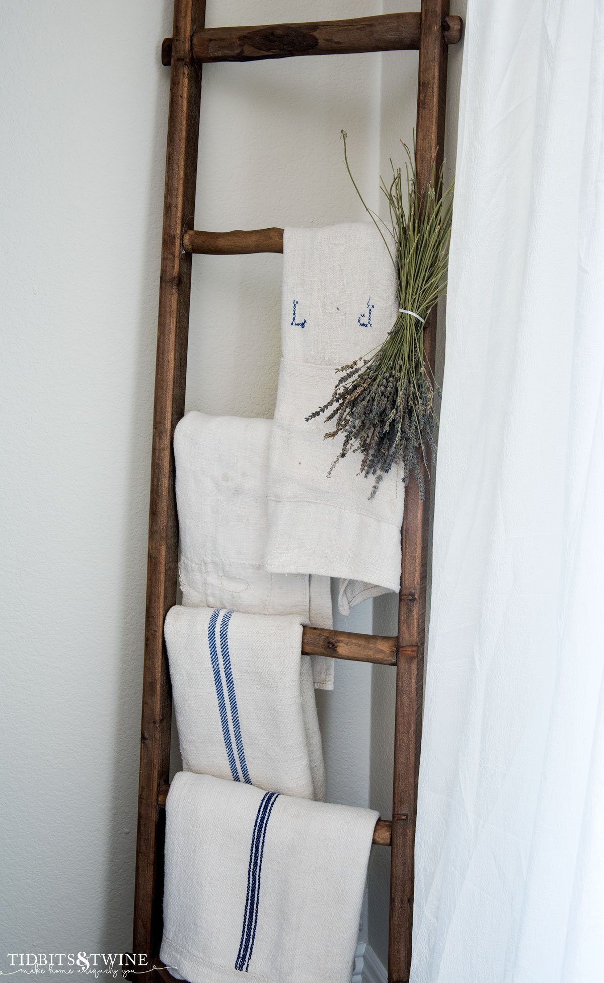 wooden blanket ladder with antique grain sacks and dried lavender in corner of family room