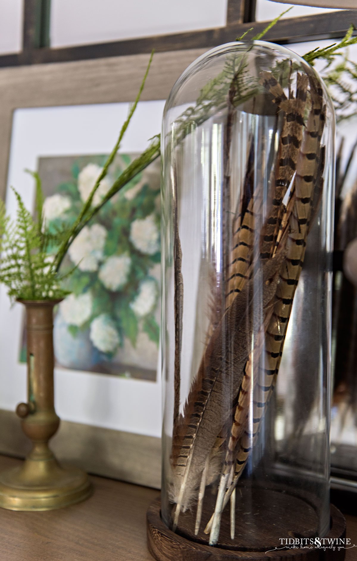 cloche filled with brown striped feathers for spring