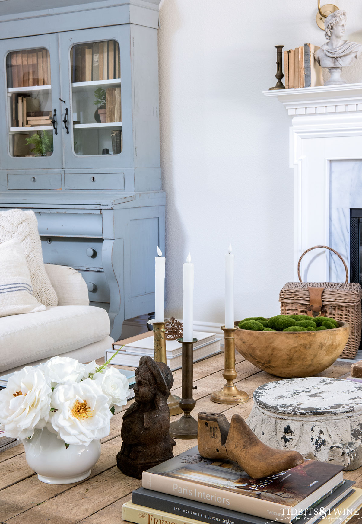 spring styled coffee table with sofa and antique blue hutch in the background