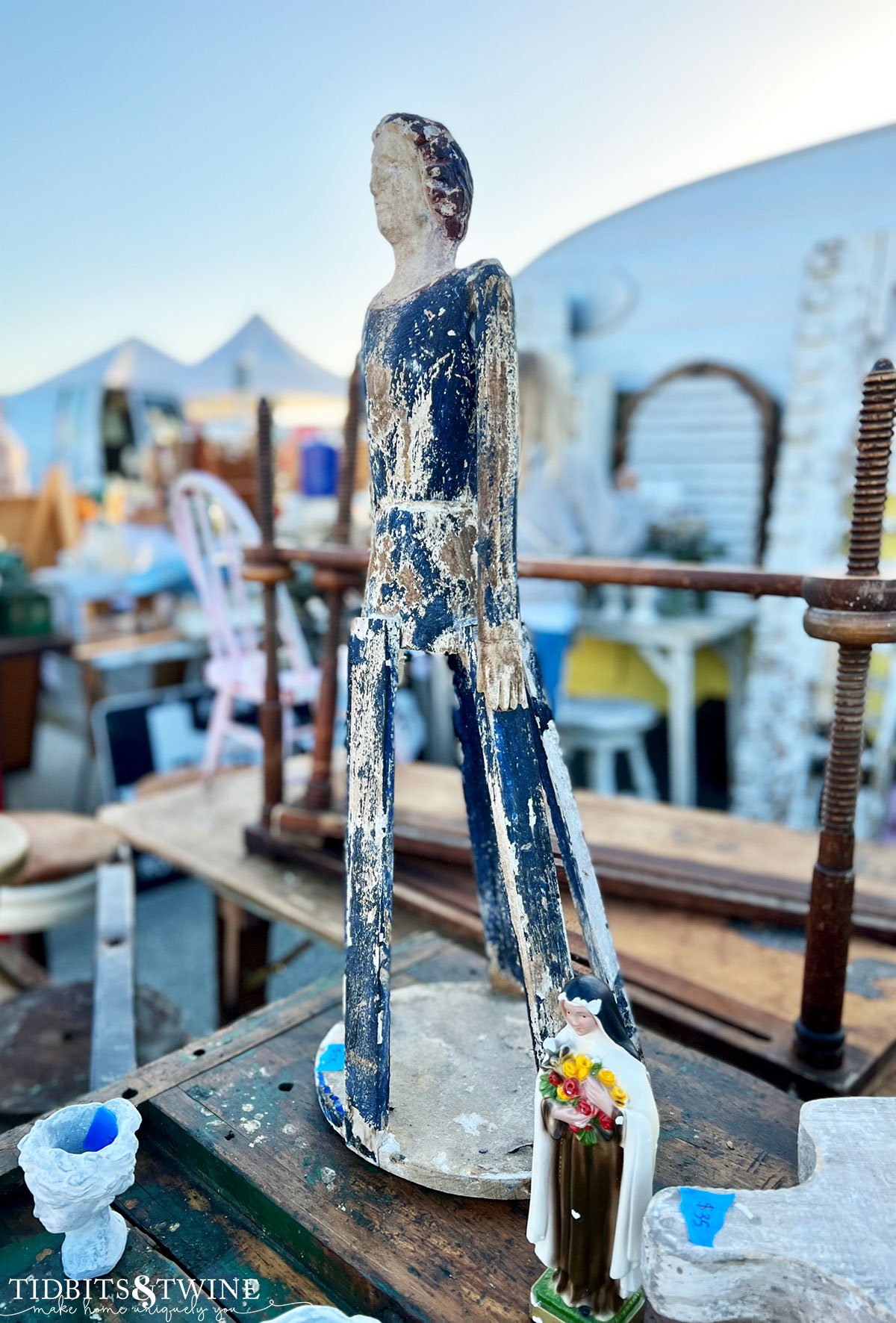 antique shabby blue santos cage doll on table display at antique fair