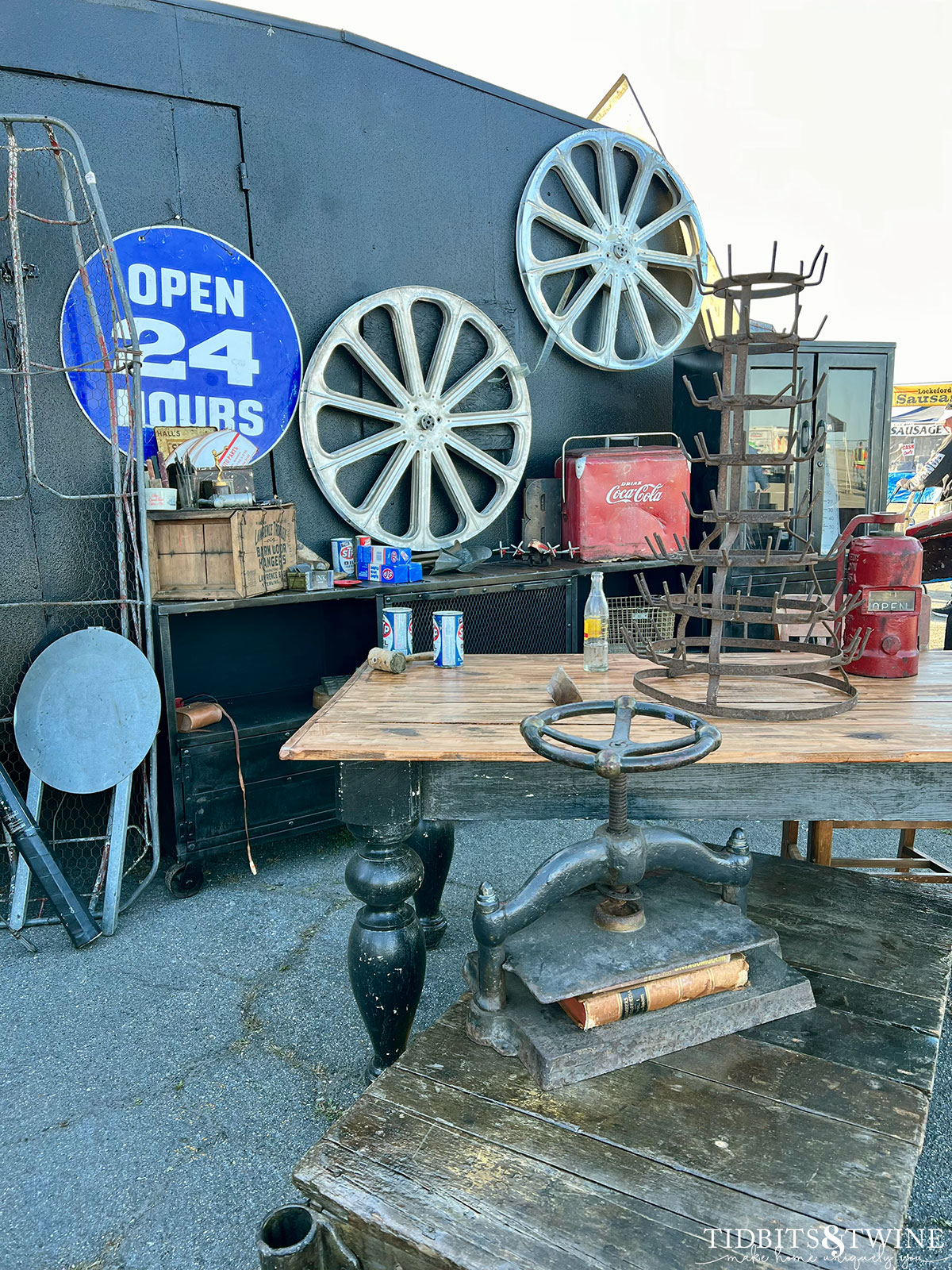 black trailer with film reels on side and black table in front holding bottle drying rack