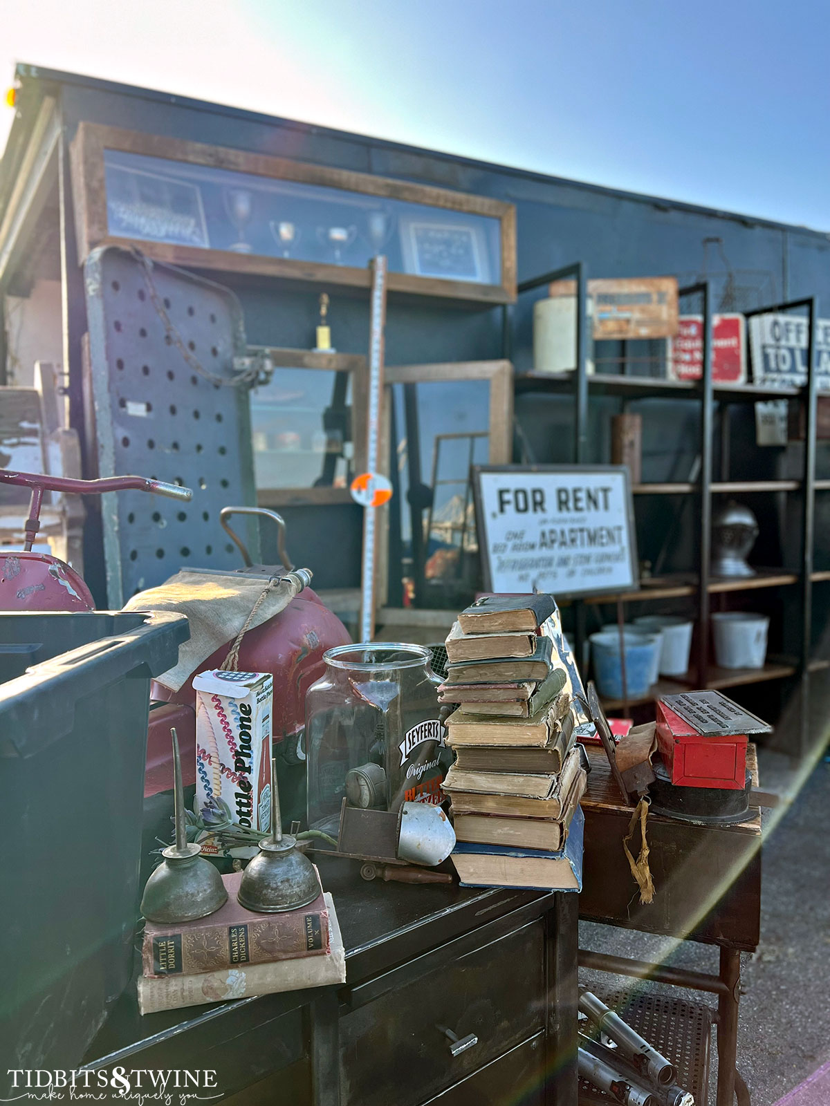 antique fair booth with industrial items like oil cans buckets and shelves