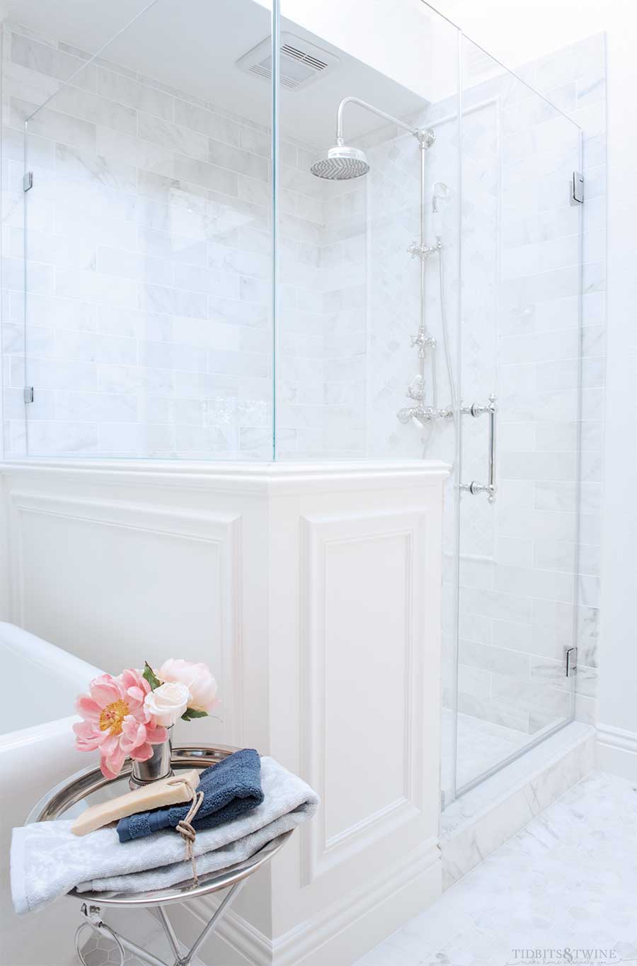 French master bathroom with carrara shower pony wall next to freestanding tub