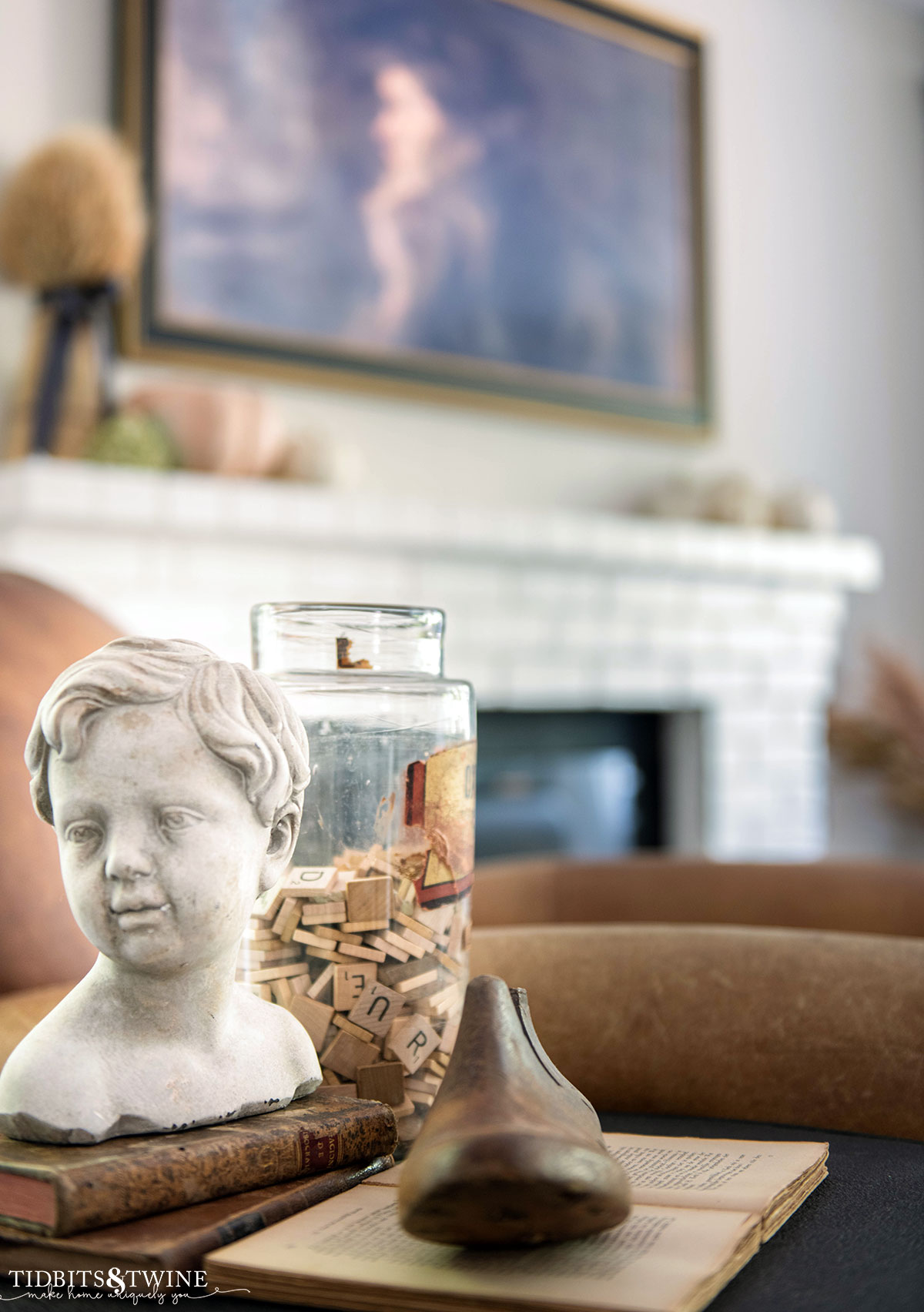 side table vignette with bust statue, vintage jar with scrabble tiles, wooden shoe form and fall mantel in background