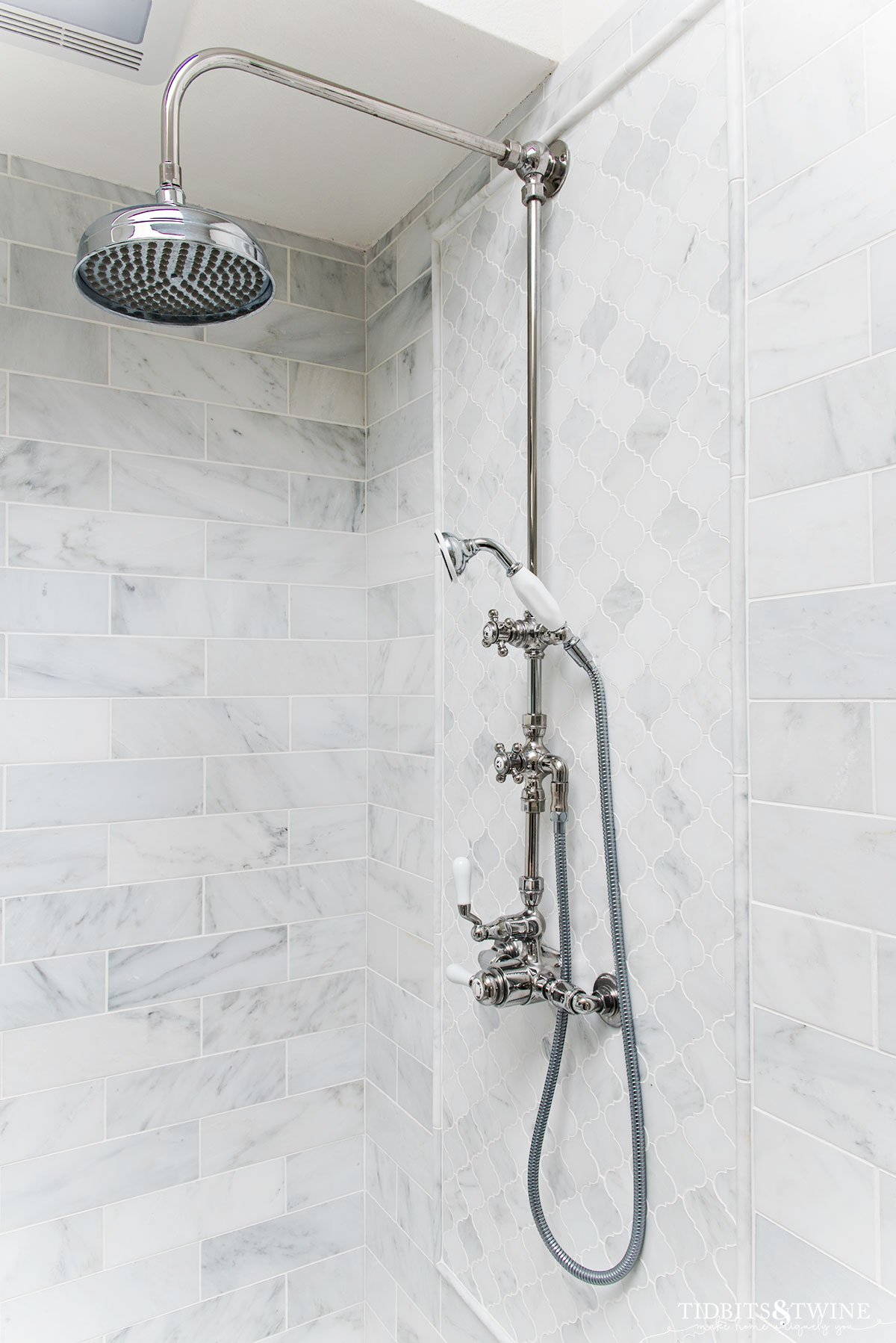 exposed pipe shower with crosshandles in carrara marble shower walls and floor