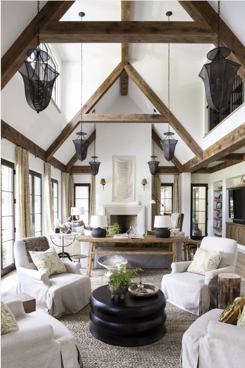 family room with vaulted ceiling with wood beams and seating area with four chairs and coffee table