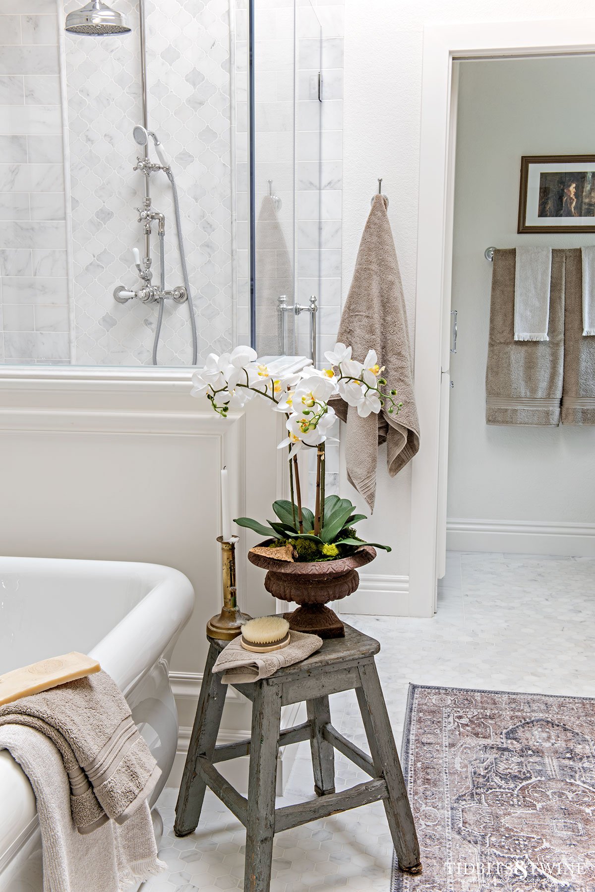 carrara marble shower enclosure with pony wall and freestanding tub