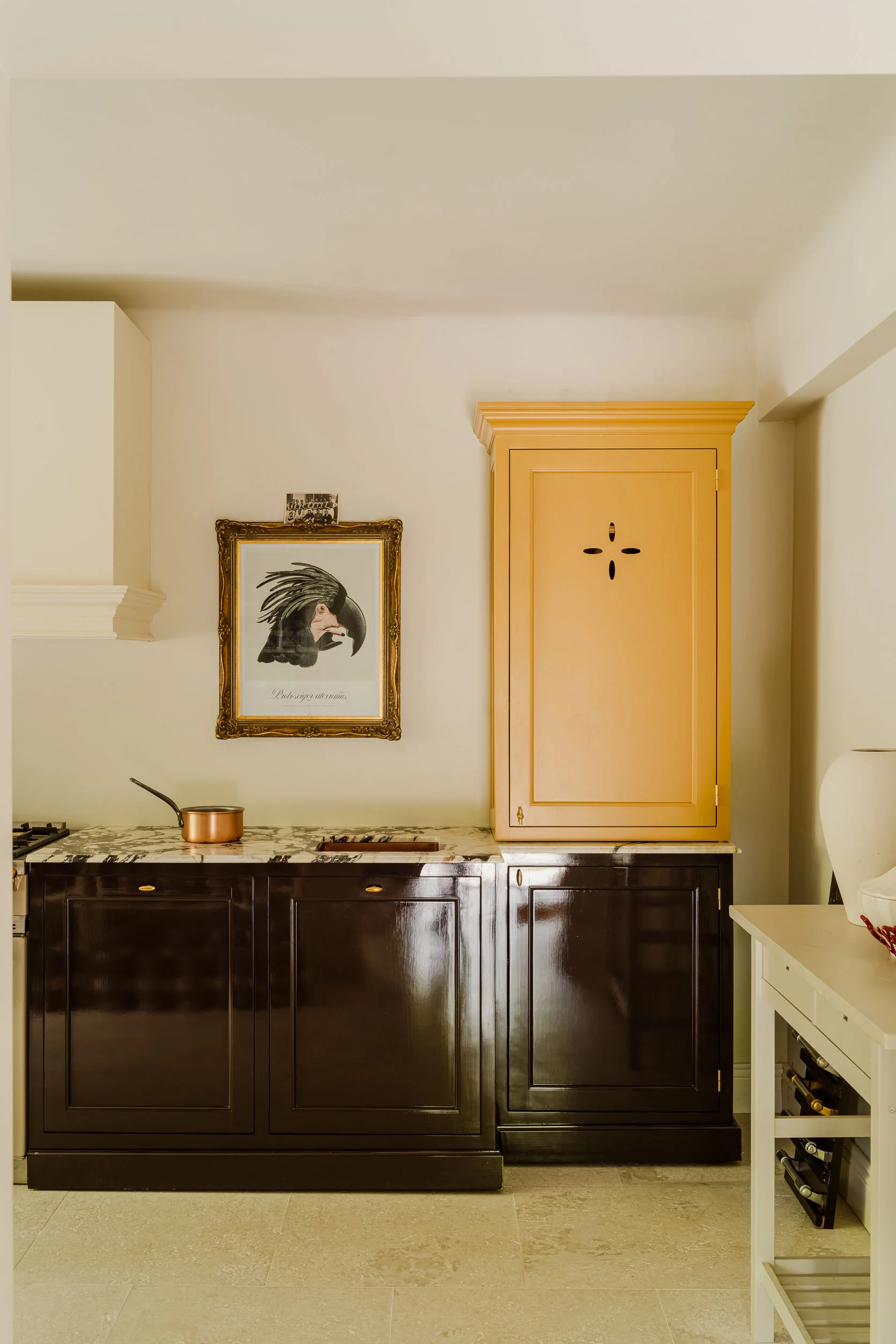 kitchen with black lower cabinets and yellow upper cabinet with cutout