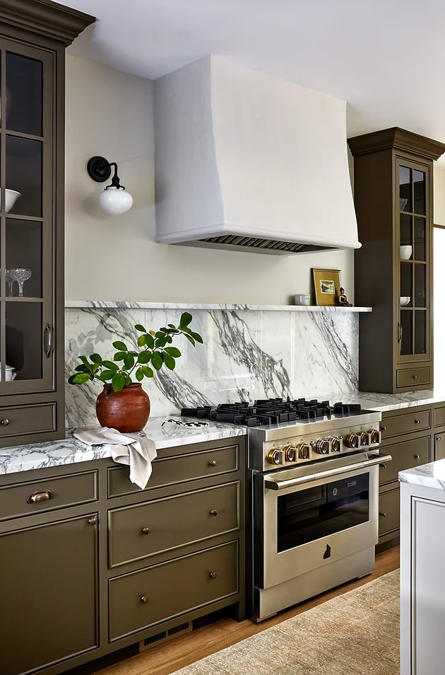 olive green kitchen cabinets with backsplash marble ledge above range