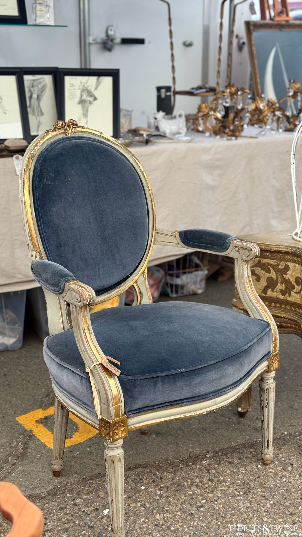 blue velvet upholstery on an antique french chair on display at an antique fair