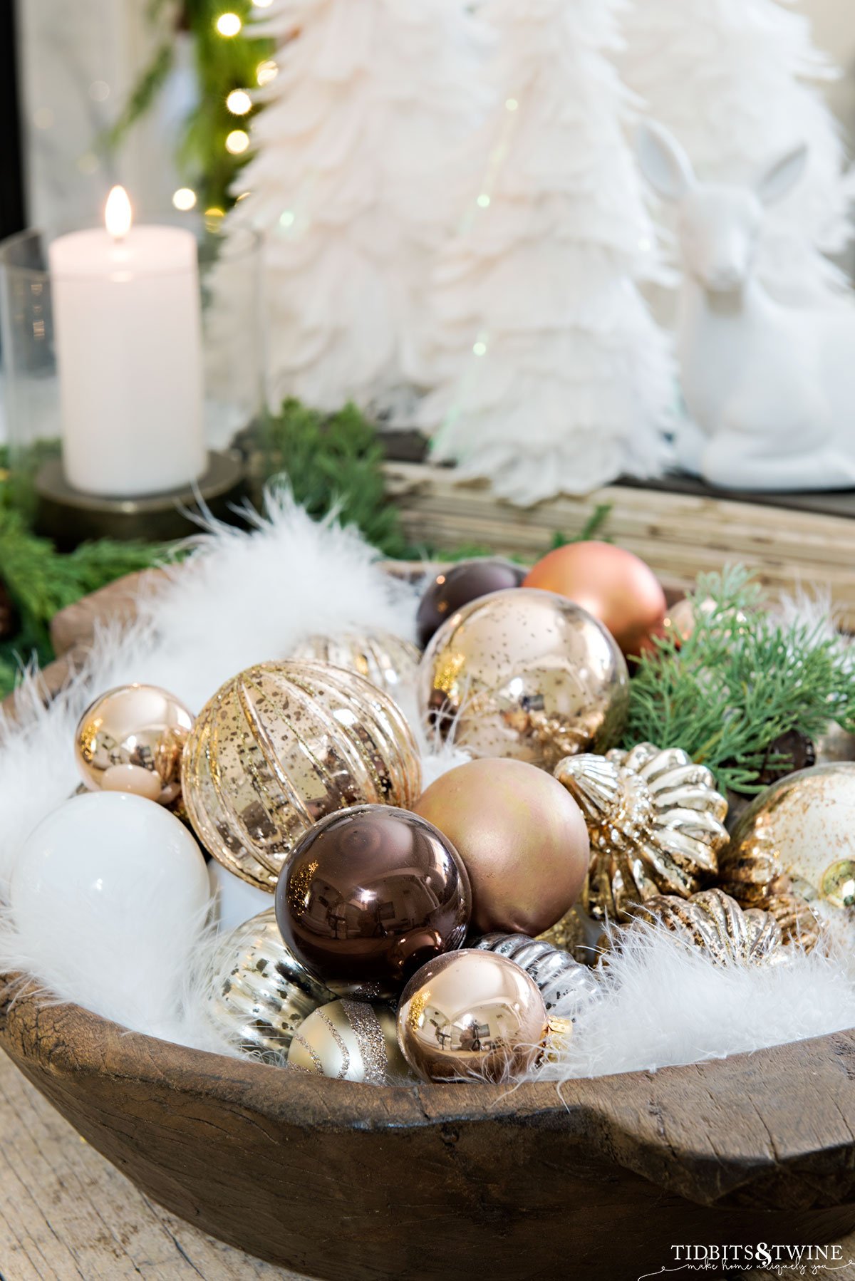 closeup of wooden dough bowl full of gold silver white brown and copper christmas ornaments