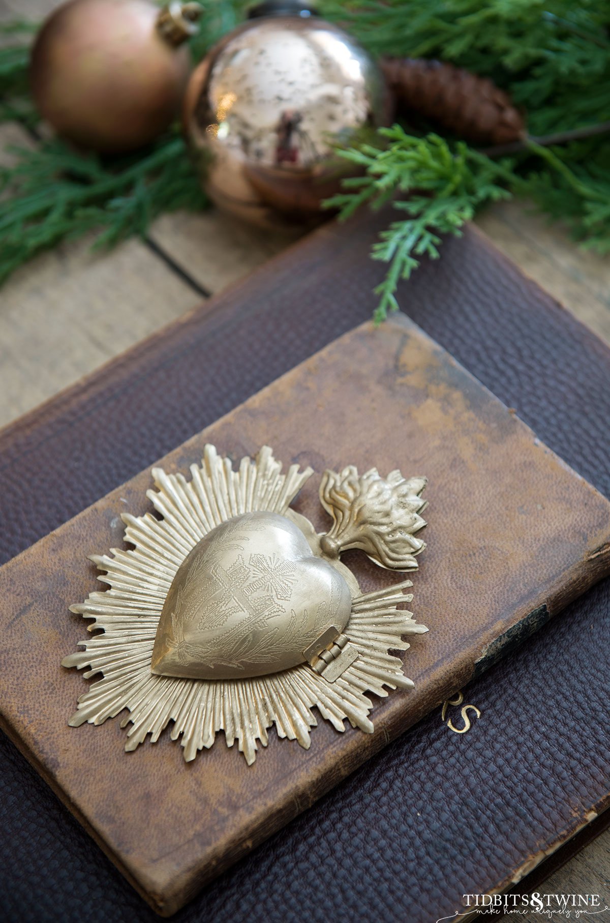 stack of vintage leather books with a gold heart box sitting on top