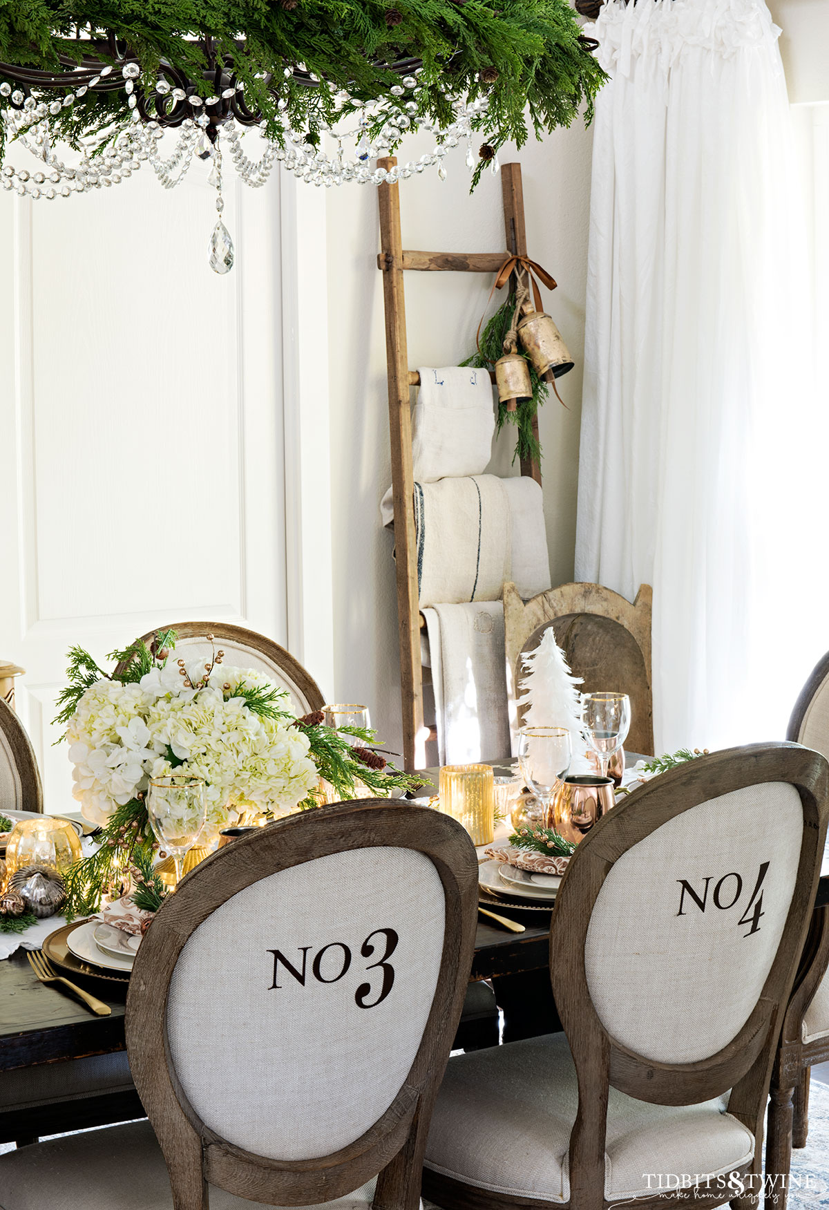 french christmas dining room decorated with neutrals and round linen numbered chairs